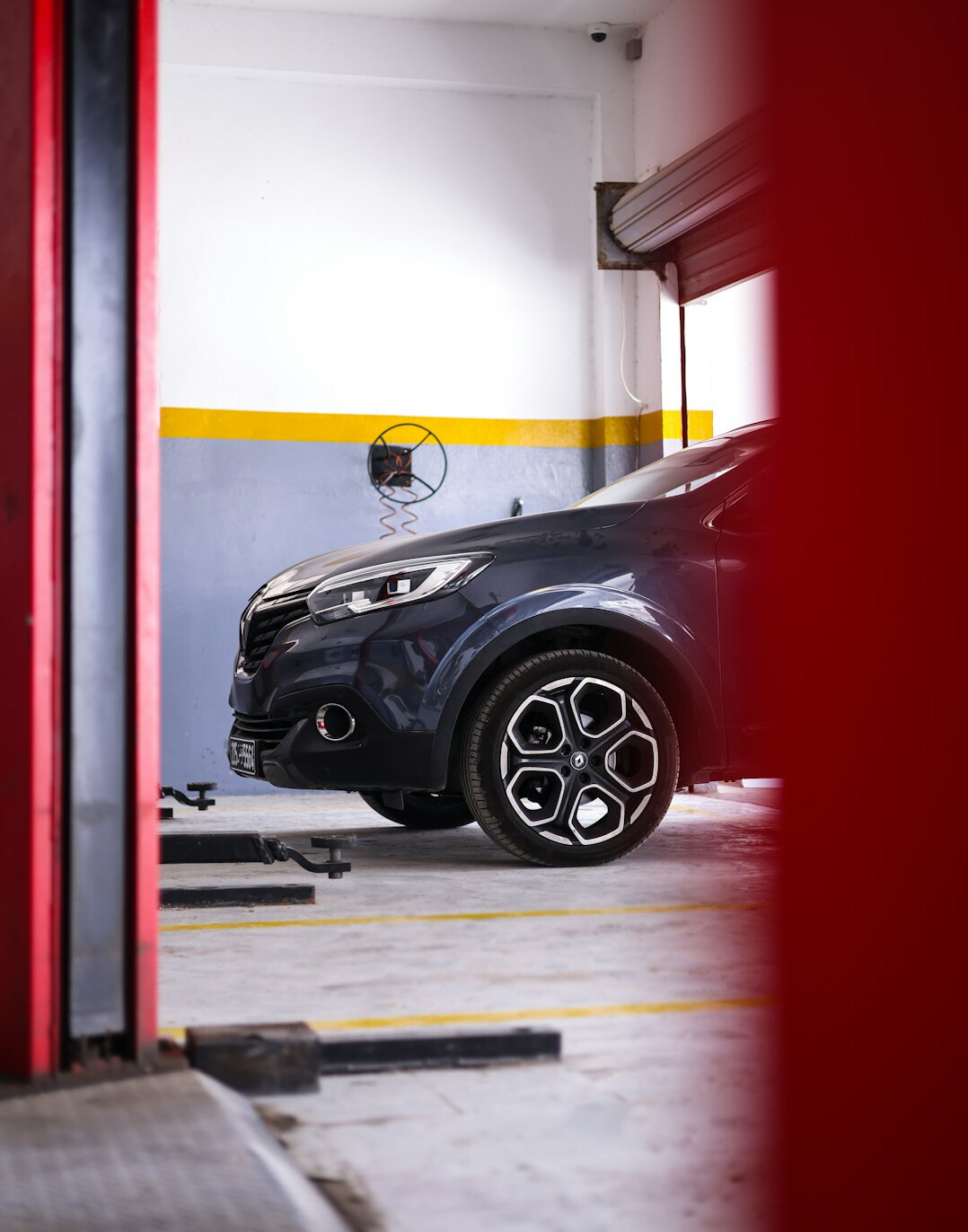 Car lifted on a hydraulic lift in a garage